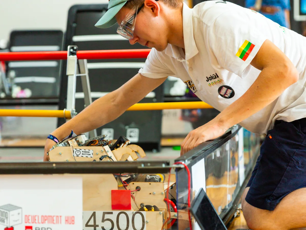 Jokūbas setting the robot up on the field at the Bucharest Twin Cup