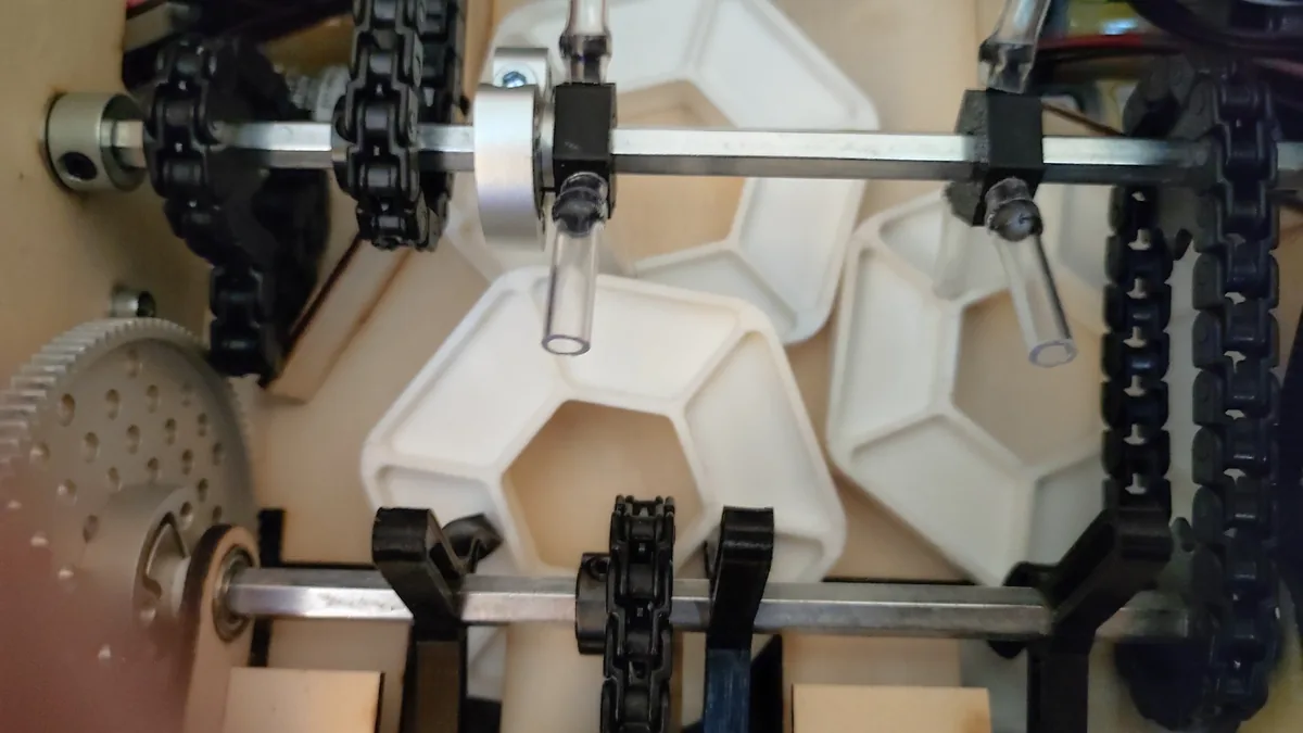 Three PIXELS wedged against one another inside the transfer, between the chain-driven shafts